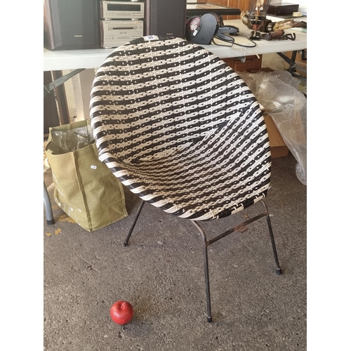 840 - An unusual mid century wicker style tub chair on a tubular steel base. Crafted from weather resistan... 