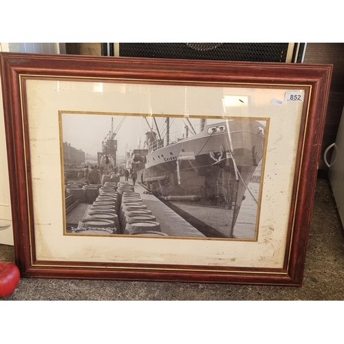 852 - A large framed photograph of a Guinness ship getting loaded with barrels at Dublin Dock. Nice piece