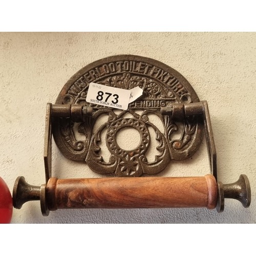 873 - A charming cast metal toilet roll holder with wooden handle reading Waterloo Toilet Fixture.