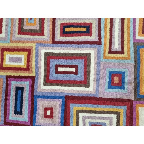 369 - A super funky, wool rug. featuring a multi-coloured pattern of concentric rectangles. L200cm x W140c... 