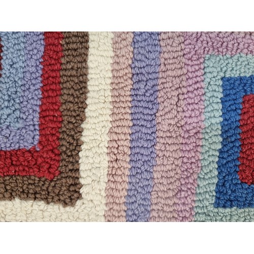 369 - A super funky, wool rug. featuring a multi-coloured pattern of concentric rectangles. L200cm x W140c... 