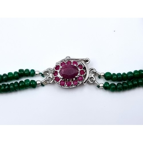 50 - Star Lot : A beautiful 228 carat Cabochon Emerald two strand necklace, featuring a lovely Ruby halo ... 
