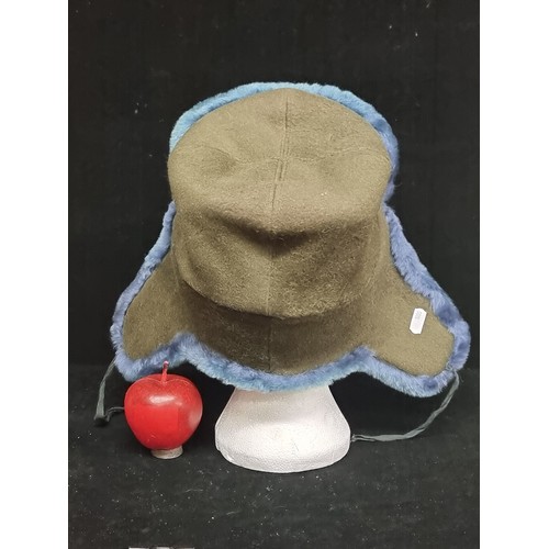 494 - A very warm ushanka hat with a Russian military pin and deep turquoise lining.