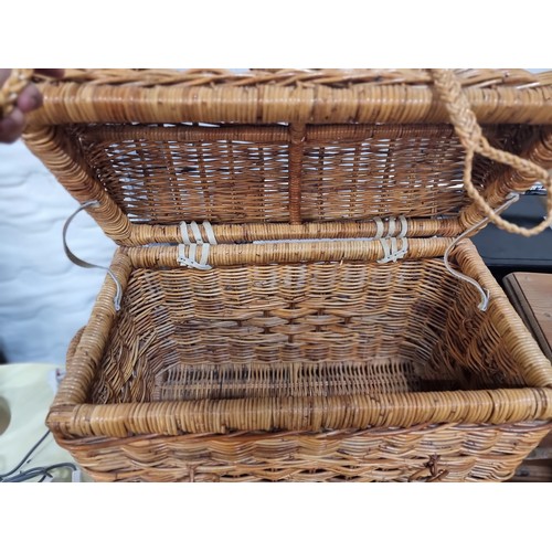 763 - A delightful good sized woven wicker  basket with hinged lid, ropes closing ties  and two carry hand... 