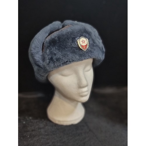 793 - An extra cozy original vintage Soviet Ushanka with enamel pin to front, and brilliant blue fur for c... 