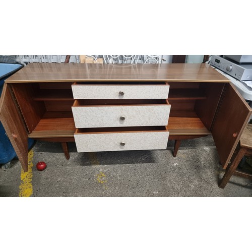 415 - A very handsome Mid Century Modern sideboard. This offers wonderful storage, comprising of two drawe... 