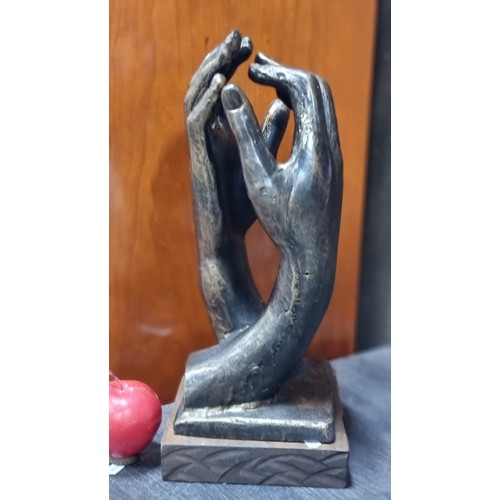 674 - A stuning remarkaby heavy cast bronze elegant sculpture of two hands touching, supported by a wooden... 