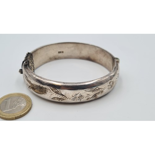 18 - A stunning silver bangle bracelet with incised foliate ornament made by Joseph Smith and Sons and da... 