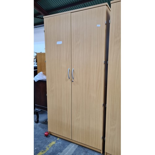 298 - A large office cabinet which opens to reveal four adjustable metal shelves inside.