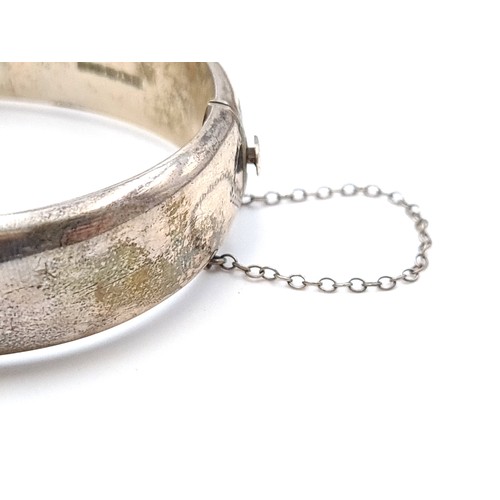 444 - A stunning vintage Sterling silver bangle bracelet with incised foliate ornament dating to 1968 and ... 