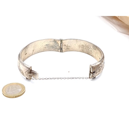 444 - A stunning vintage Sterling silver bangle bracelet with incised foliate ornament dating to 1968 and ... 