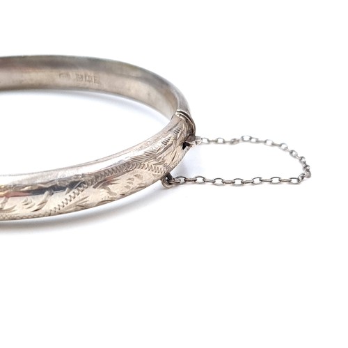 408 - A beautiful Sterling silver bangle bracelet with incised floral ornament, marke C.M. Birmingham and ... 