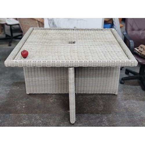 724 - A good sized square rattan outdoor dinning table in white with space for umbrella in the centre.