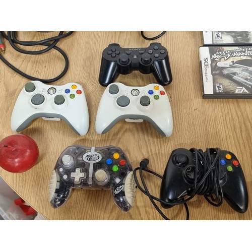 875 - A 60gb Xbox 360 and an original Xbox along with 7 controllers and accompanying cables and two games.... 