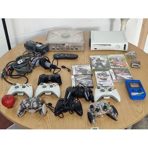 875 - A 60gb Xbox 360 and an original Xbox along with 7 controllers and accompanying cables and two games.... 