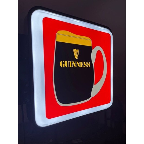 364 - A neatly sized double sided light-up sign, advertising Guinness in shades of red, black and white. W... 