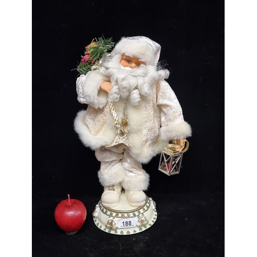 188 - A free-standing musical, articulated Santa Claus figure. Beautifully dressed in a cream, crushed vel... 