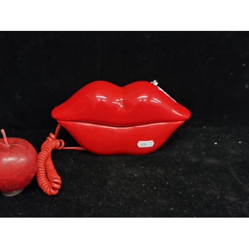 220 - A fabulous lips telephone with push button numbers and a pause and redial feature. In a vibrant glos... 