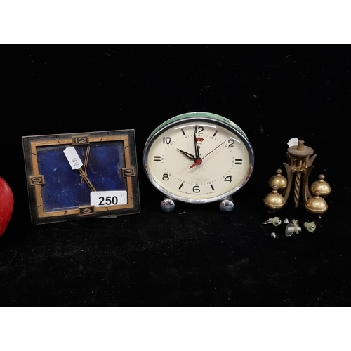 250 - Two vintage desk clocks including a rectangular brass 8 day example and a retro looking oval Polaris... 