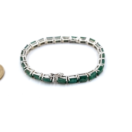 413 - A beautiful example of an Emerald tennis bracelet with 24 matched natural Columbian Emeralds and set... 