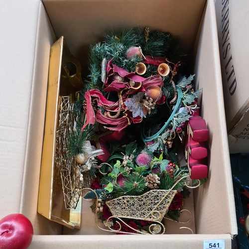 541 - A large box of Christmas ornaments including a large gold tray, Gold Santa sleigh, wreaths, garlands... 