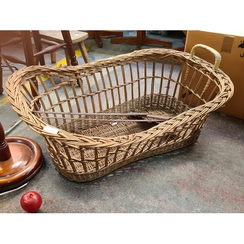 543 - Three items including a very large wicker basket with a handle and two long set squares.