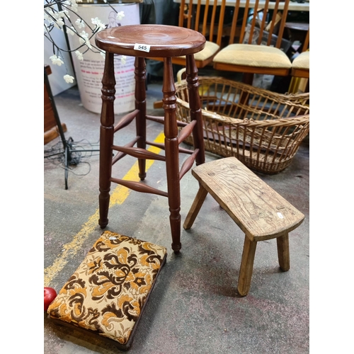 545 - Three vintage stools including a turned wood barstool, a rustic milking footstool with bun feet anti... 