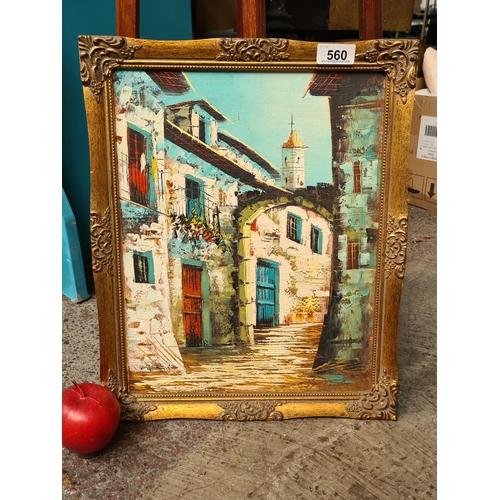 560 - A charming original oil on board painting showing a characterful medieval Mediterranean street, rend... 