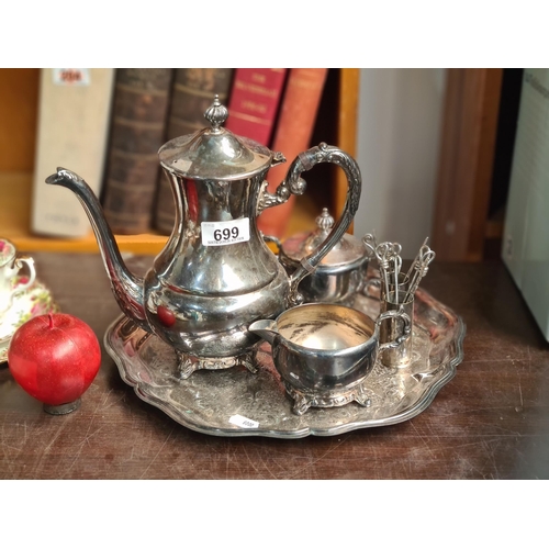 699 - A nice silver plated tea set with coffee pot, creamer and sugar bowl held on an incised tray. Along ... 