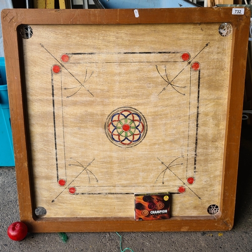 732 - A carrom tabletop playing board with hand painted playing surface, netted sockets and a set of carrr... 