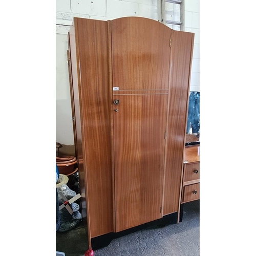 765 - A beautiful example of a Mid Century Modern wardrobe. A very well-maintained example designed with h... 