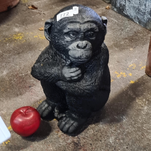 772 - A reconstituted stone garden figure. Depicting a young chimpanzee. Hand-painted in realistic colouri... 