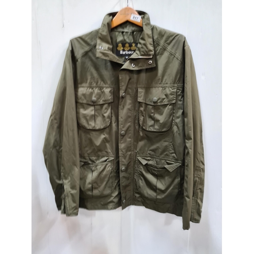 817 - A Barbour waterproof rain jacket in a khaki green, with four pockets to front and three pockets to t... 