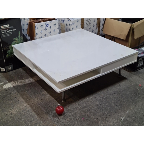 822 - A sleek and stylish white gloss square modern coffee table with two drawers and shelves below for pl... 