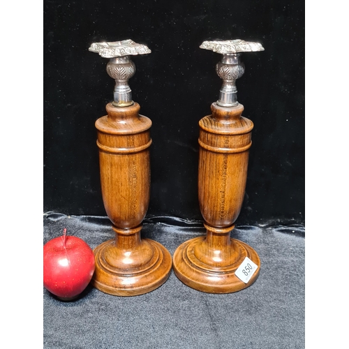 850 - Two beautiful turned wood candle stick holders with silver plated ornate tops.