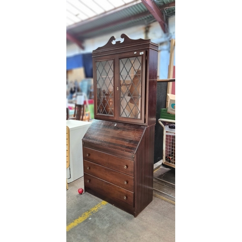 896 - A charming vintage secretary bookcase, with a carved pediment, three deep drawers and a hinged writi... 