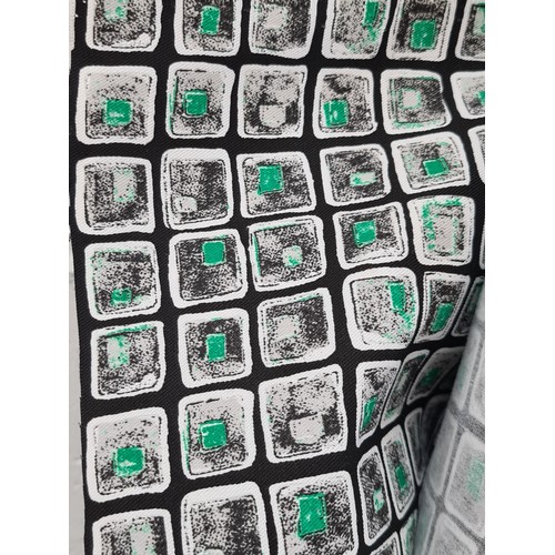 885 - A large bolt of durable fabric in a striking pattern of white and green squares on a black backgroun... 