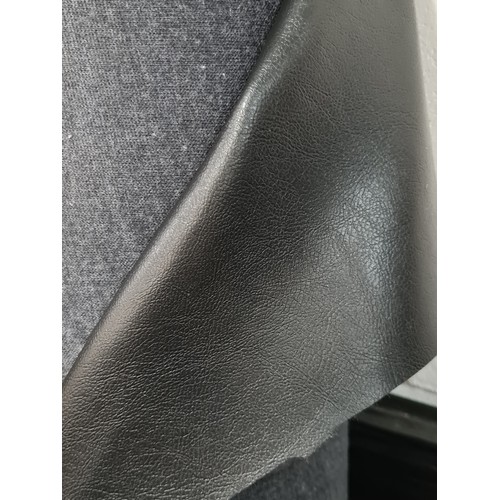 887 - A large bolt of very useful fabric, with a grey cotton blend on one side, with a black leatherette o... 