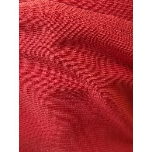 890 - A large bolt of vibrant red stretch fabric. This fabric is finely ribbed with excellent stretch capa... 