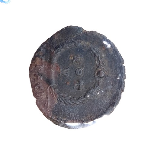 573 - An antique Roman coin. A Jovian Follis bronze coin, issued 363-364 AD. 17.6mm and 2.78g. Very fine a... 