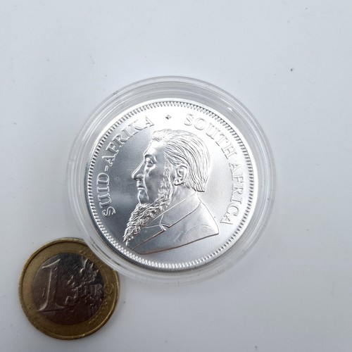 404 - A one ounce .999 fine silver Krugerrand coin. Dated 2020.  Presented in a protective case and is in ... 