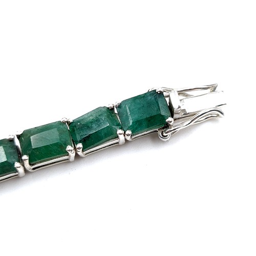 413 - A beautiful example of an Emerald tennis bracelet with 24 matched natural Columbian Emeralds and set... 