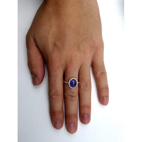 419 - Star Lot: A striking 14 carat Gold Tanzanite and Diamond ring, set with a vivid blue 4.5 carat caboc... 