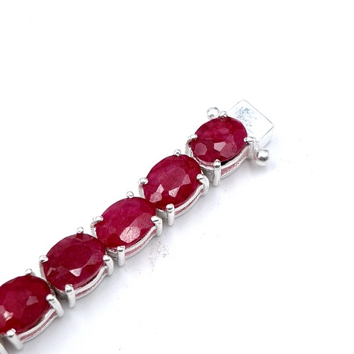 414 - An Oval Ruby tennis bracelet, of 20 grams and set in sterling silver. A beautiful tennis bracelet Wi... 