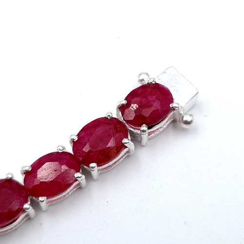 414 - An Oval Ruby tennis bracelet, of 20 grams and set in sterling silver. A beautiful tennis bracelet Wi... 