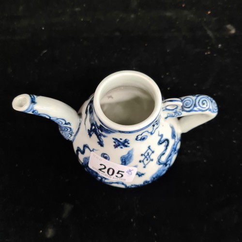 205 - An early nineteenth Century porcelain teapot with hand-painted blue glaze depicting sparring dragons... 