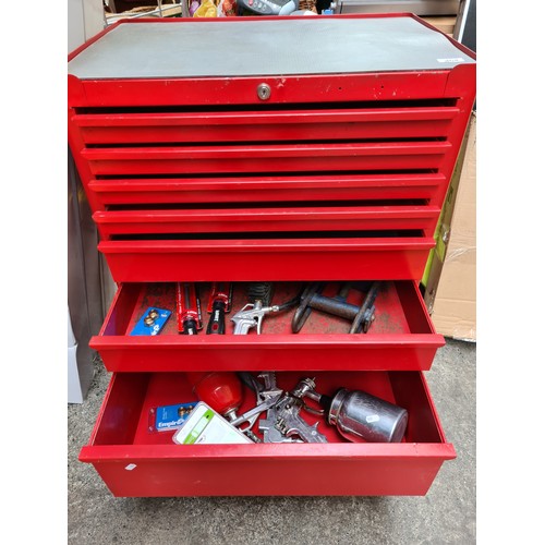 464 - A super seven-drawer metal rolling tool chest in castors, with contents including spray guns and foi... 