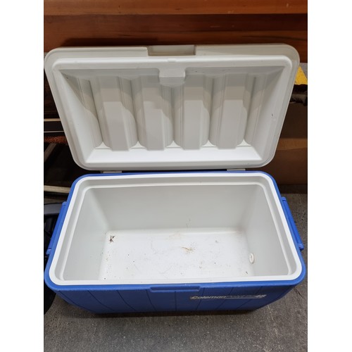 521 - A large Coleman PolyLite 48 portable ice box with carry handles. In a white and blue finish.