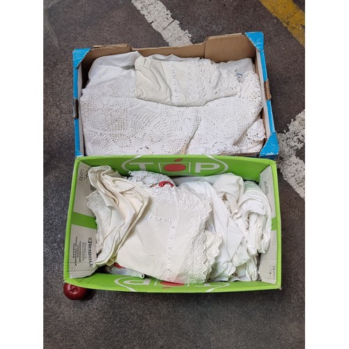 606 - Two boxes of vintage table cloths, embroidery and napkins.