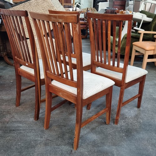 394 - Four slat back Danish style dining chairs upholstered in a smart cream fabric.